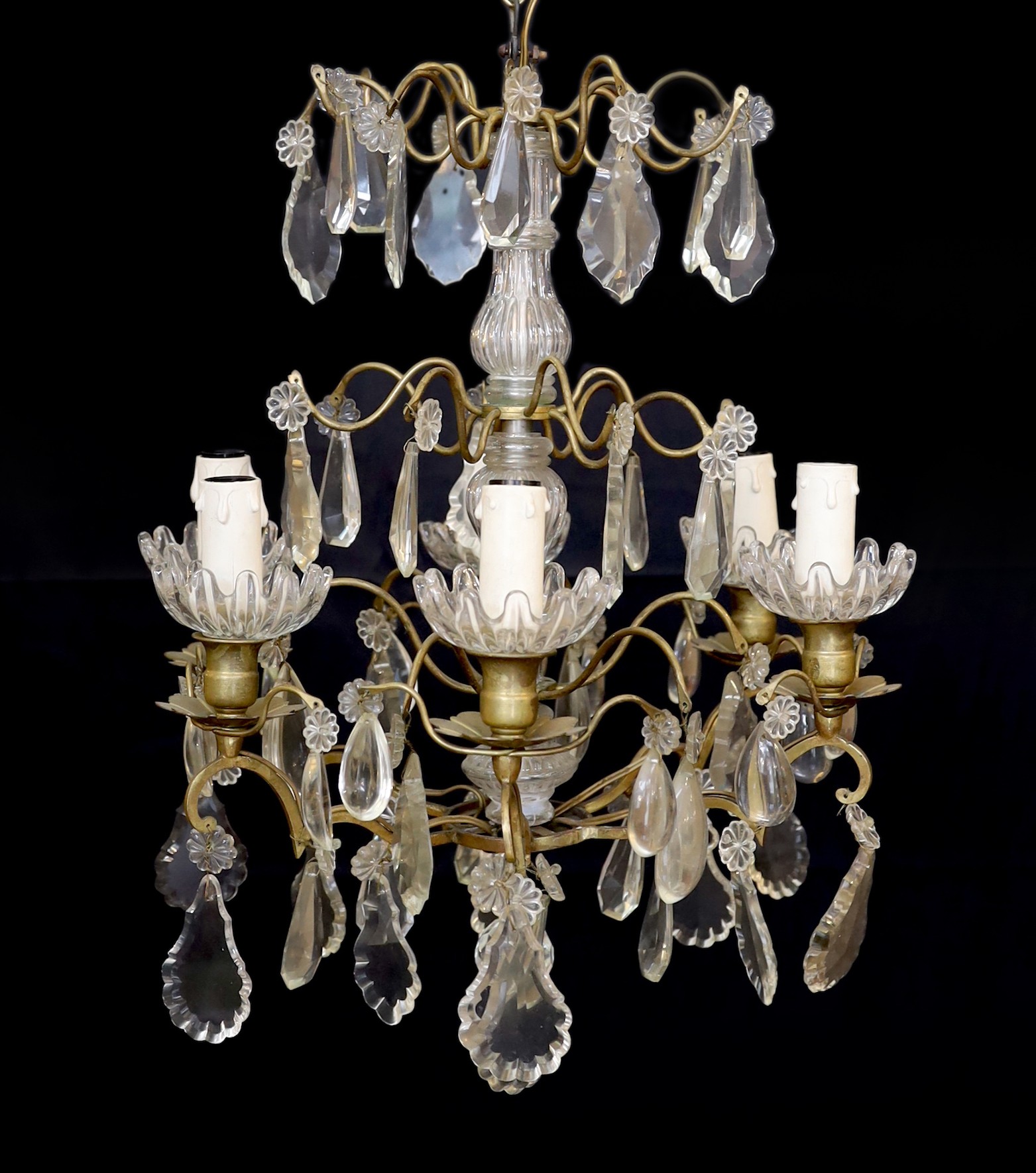 An early 20th century French bronze and cut glass six light chandelier hung with tear and lozenge shaped drops, drop 50cm. width 35cm